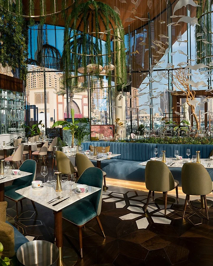 An elegant restaurant interior with tall windows and a city view